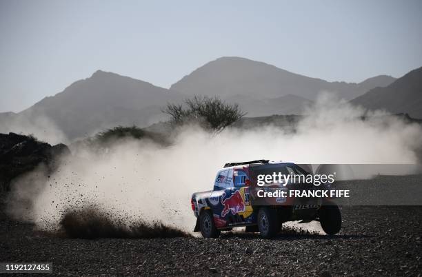 Toyota's driver Nasser Al-Attiyah of Qatar and his co-driver Mathieu Baumel of France compete during the Stage 2 of the Dakar 2020 between Al Wajh...