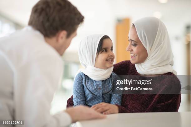 afghan mother and daughter visit the doctor stock photo - afghan ethnicity imagens e fotografias de stock