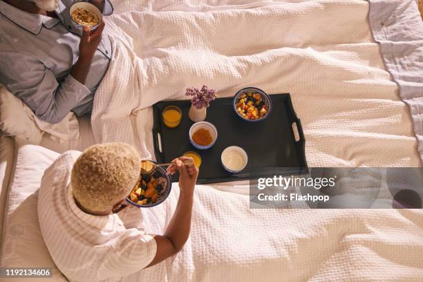 mature couple enjoy breakfast in bed - breakfast in bed tray stock-fotos und bilder