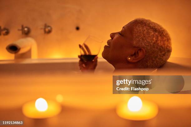 Mature woman relaxes in bath