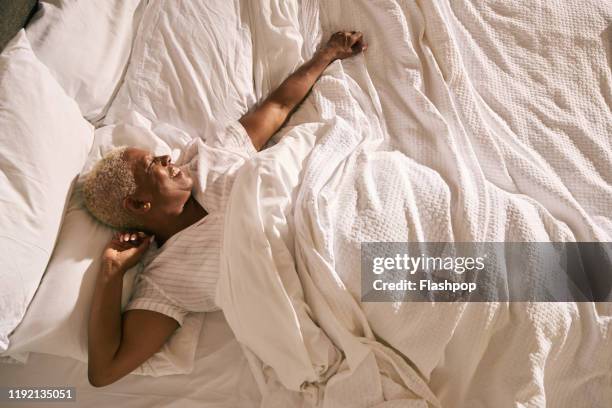 mature woman in bed (morning) - black man sleeping in bed stock-fotos und bilder