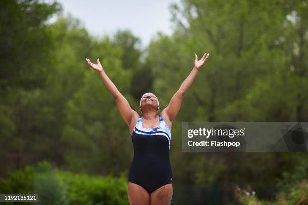 portrait of a mature woman with her arms outstretched - 儀式の踊り ストックフォトと画像