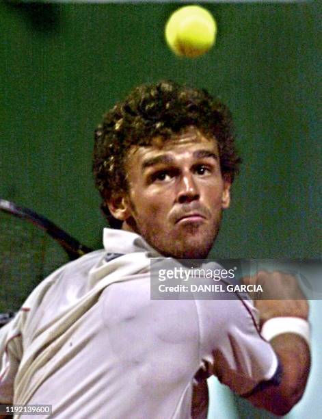 Brazilian tennis player Gustavo Kuerten gets ready to hit the ball 20 February 2001 in a match for the AT&T Cup against Australian Richard Fromberg...