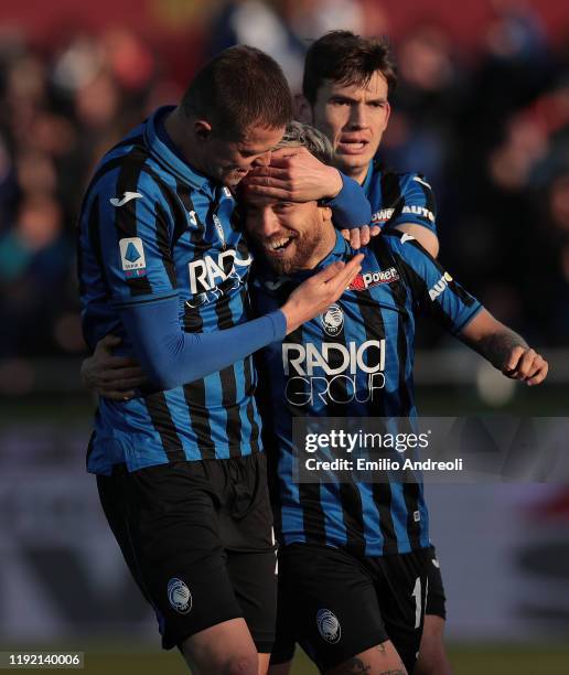 Alejandro Gomez of Atalanta BC celebrates with his team-mates Josip Ilicic and Marten De Roon after scoring the opening goal during the Serie A match...