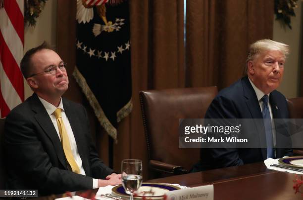 President Donald Trump and Acting chief of staff Mick Mulvaney listen to comments during a luncheon with representatives of the United Nations...