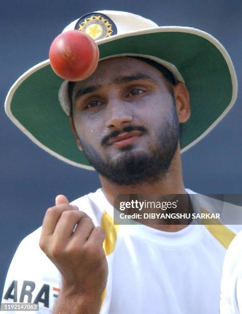 Indian Cricket player Harbhajan Singh tosses a ball during a practice session on the eve of the Irani Trophy match in Madras, 17 September 2003....