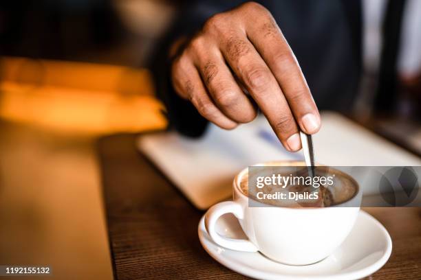 businessman mixing coffee hand close up. - mixing spoon stock pictures, royalty-free photos & images
