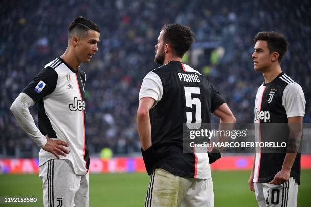 Juventus' Portuguese forward Cristiano Ronaldo, Juventus' Bosnian midfielder Miralem Pjanic and Juventus' Argentine forward Paulo Dybala react during...