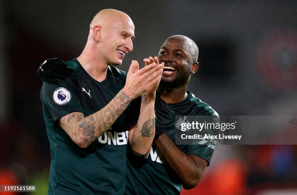 Jonjo Shelvey of Newcastle celebrate with team mate Jetro Willems after the Premier League match between Sheffield United and Newcastle United at...