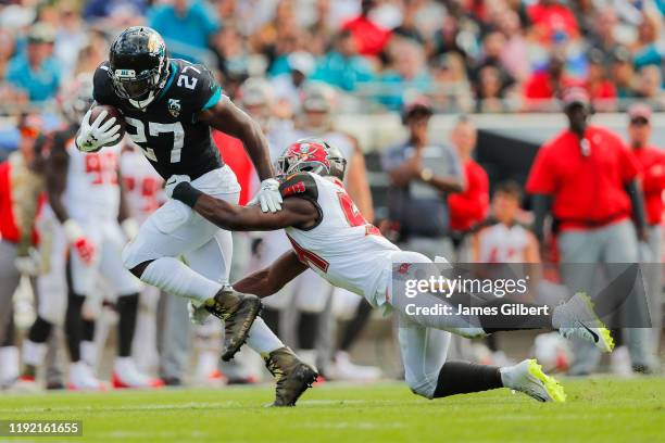 Leonard Fournette of the Jacksonville Jaguars is tackled by Lavonte David of the Tampa Bay Buccaneers during the second quarter of a game at TIAA...