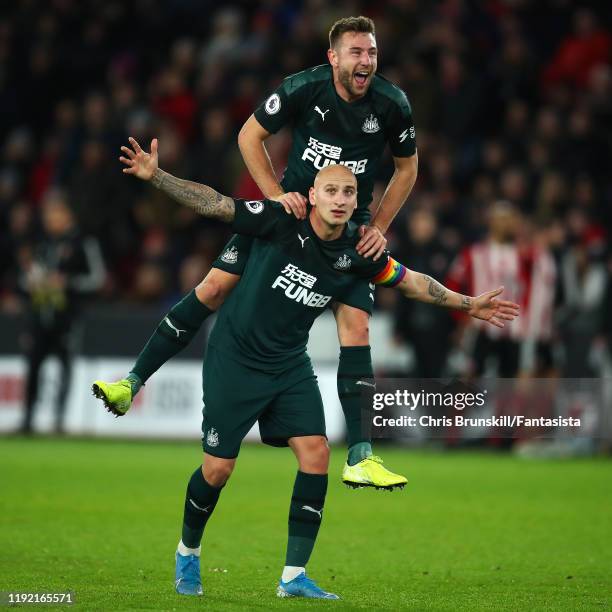 Jonjo Shelvey of Newcastle United celebrates scoring his side's second goal with team-mate Paul Dummett during the Premier League match between...