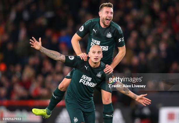 Jonjo Shelvey of Newcastle celebrate with team mate Paul Dummett during the Premier League match between Sheffield United and Newcastle United at...