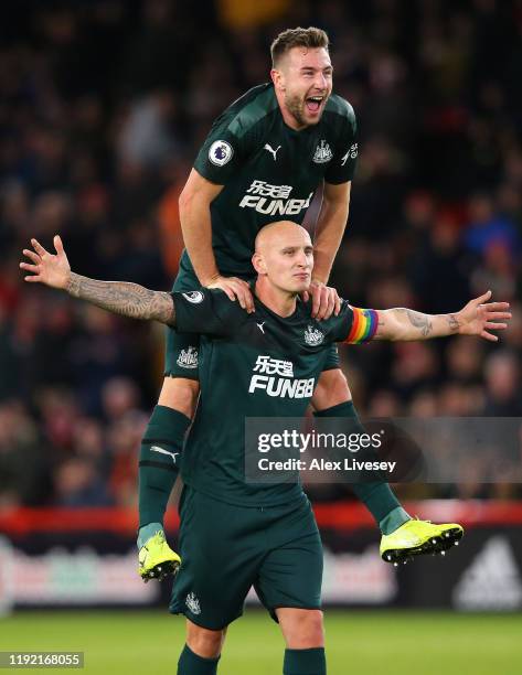 Jonjo Shelvey of Newcastle celebrate with team mate Paul Dummett during the Premier League match between Sheffield United and Newcastle United at...