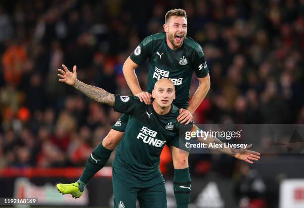 Jonjo Shelvey of Newcastle celebrate with team mate Paul Dummett during the Premier League match between Sheffield United and Newcastle United at...