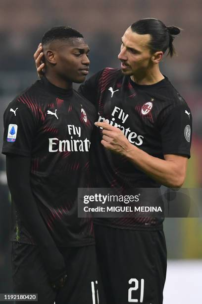 Milan's Swedish forward Zlatan Ibrahimovic comforts AC Milan's Portuguese forward Rafael Leao at the end of the Italian Serie A football match AC...