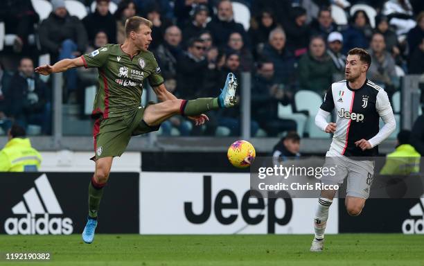 Ragnar Klavan of Cagliari and Aaron Ramsey of Juventus during the Serie A match between Juventus and Cagliari Calcio at Allianz Stadium on January 6,...