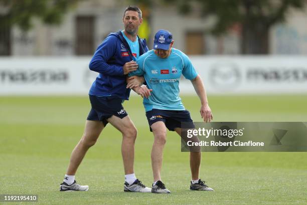 Assistant coaches Jade Rawlings and Gavin Brown are seen during a North Melbourne Kangaroos AFL training session at Arden Street Ground on December...