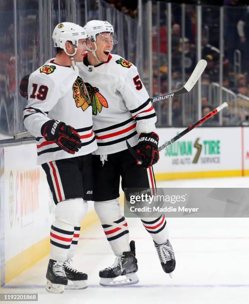 Jonathan Toews of the Chicago Blackhawks celebrates with Connor Murphy after scoring the game winning goal in overtime to defeat the Boston Bruins...