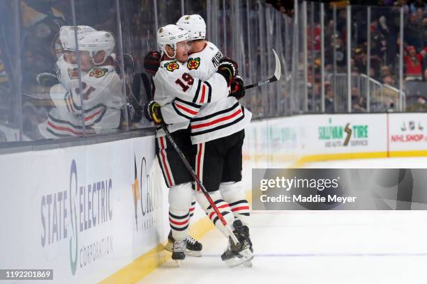 Jonathan Toews of the Chicago Blackhawks celebrates with Connor Murphy after scoring the game winning goal in overtime to defeat the Boston Bruins...