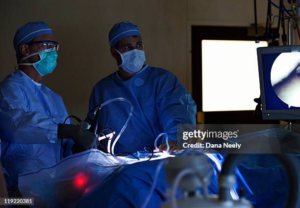 surgeon performing laproscopic surgery on hip. - laparoscopy 個照片及圖片檔