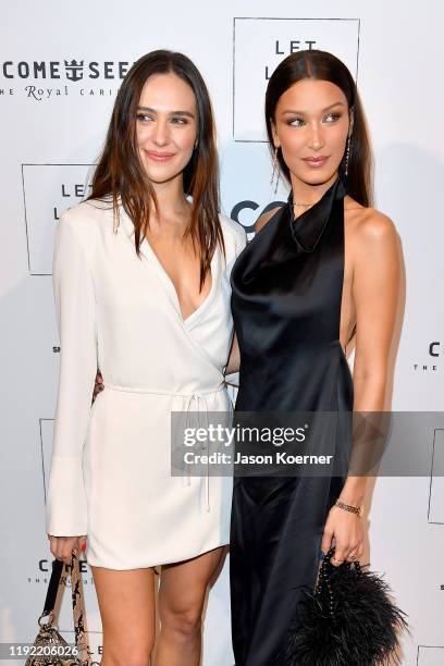 Devon Lee Carlson and Bella Hadid attend the Core x Let Love Rule Benefit during Art Basel Miami 2019 on December 05, 2019 in Miami, Florida.