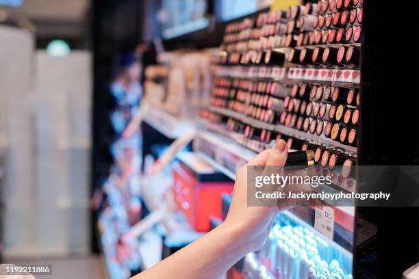 girl looking at make-up - cosmetics shopping stock pictures, royalty-free photos & images