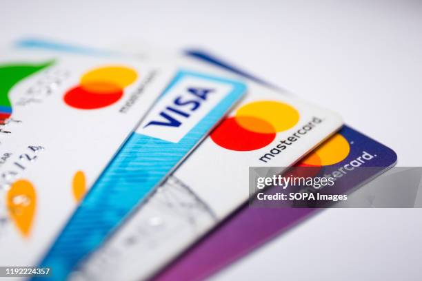 In this photo illustration a Visa credit card and Mastercard debit cards are seen displayed.