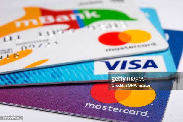 In this photo illustration a Visa credit card and Mastercard debit cards are seen displayed.