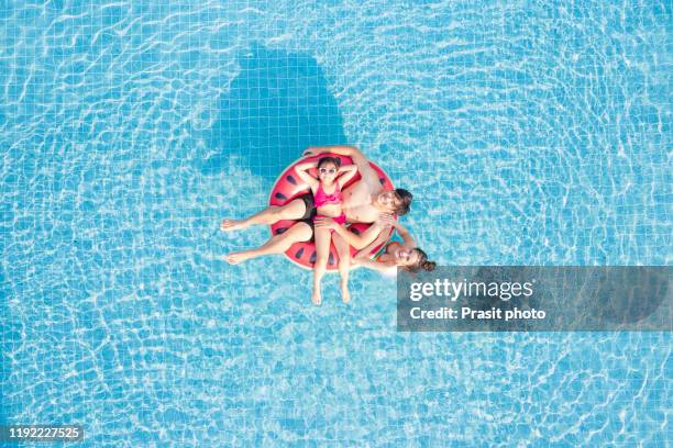 aerial view of happy asianfamily in the pool, having fun in the water, father, mother with daughter enjoying aqua park in resort, summer holidays, vacation concept - asia aerial stock pictures, royalty-free photos & images