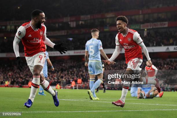 Reiss Nelson of Arsenal celebrates scoring the opening goal with Alexandre Lacazette during the FA Cup Third Round match between Arsenal and Leeds...