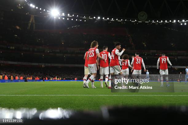 Reiss Nelson of Arsenal celebrates scoring the opening goal with team mates during the FA Cup Third Round match between Arsenal and Leeds United at...