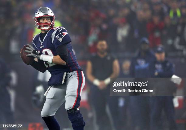 New England Patriots quarterback Tom Brady drops back to pass in the fourth quarter. The New England Patriots host the Tennessee Titans in the Wild...