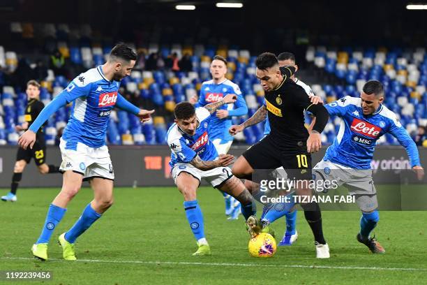 Inter Milan's Argentinian forward Lautaro Martinez challenges Napoli's Greek defender Konstantinos Manolas, Napoli's Italian defender Giovanni Di...