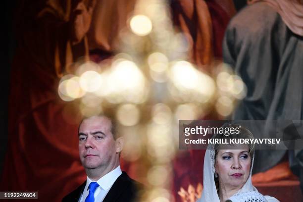 Russian Prime Minister Dmitry Medvedev and his wife Svetlana attend the celebration of a Christmas service in Christ the Savior cathedral in Moscow...