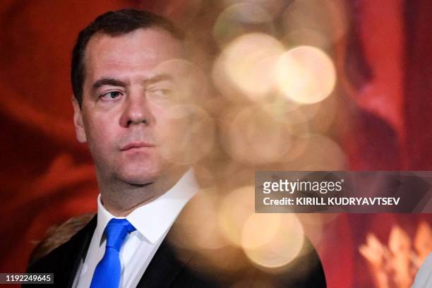 Russian Prime Minister Dmitry Medvedev attends the celebration of a Christmas service in Christ the Savior cathedral in Moscow early on January 7,...