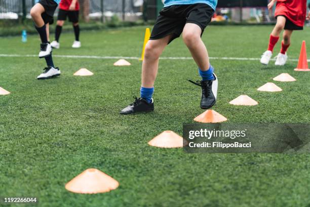 low section view of a boys soccer players practicing on field with soccer drills - sports drill stock pictures, royalty-free photos & images