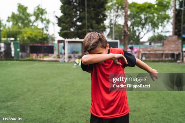 soccer player boy doing the dab dance standing on a soccer field - dab dance stock pictures, royalty-free photos & images