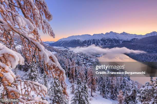 sunrise on the alpine village of sankt moritz after a snowfall - st moritz stock pictures, royalty-free photos & images