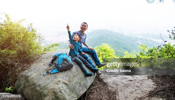 father and son on the top of the hill - backpacker asia stock pictures, royalty-free photos & images