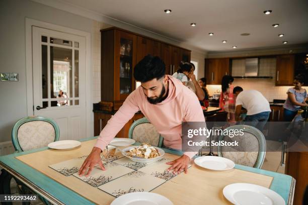 getting ready for family dinner - setting the table stock pictures, royalty-free photos & images