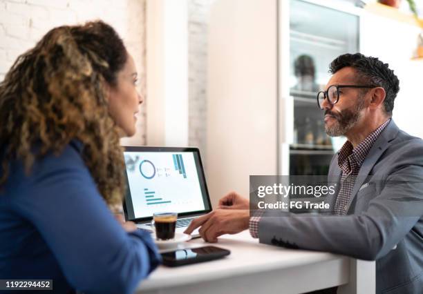 colleagues working in a cafeteria - command and control stock pictures, royalty-free photos & images