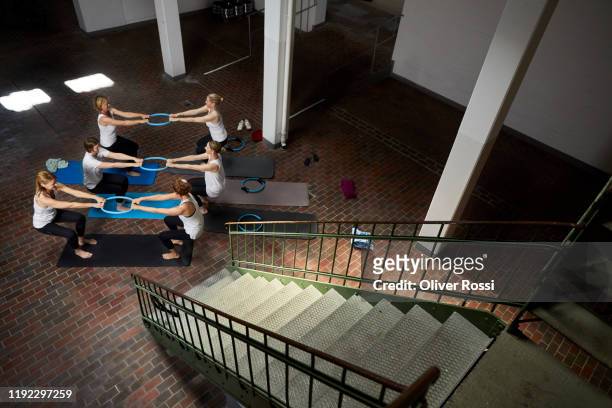 group of women practicing with pilates rings in a health club - dedication brick stock pictures, royalty-free photos & images
