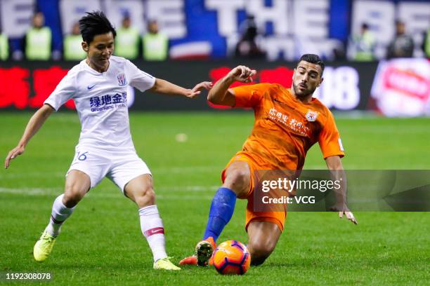 Li Yunqiu of Shanghai Greenland Shenhua and Graziano Pelle of Shandong Luneng Taishan compete for the ball during 2019 Chinese Football Association...