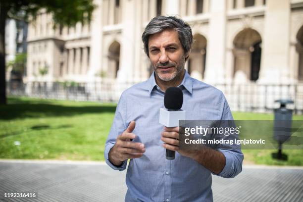 reporter covering news in buenos aires - newscaster stock pictures, royalty-free photos & images