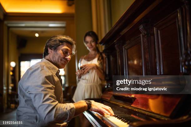 listening him playing piano and drinking red wine - fabolous musician stock pictures, royalty-free photos & images