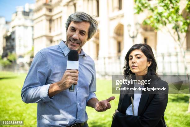 hispanic woman speaking to media - tv reporter street stock pictures, royalty-free photos & images