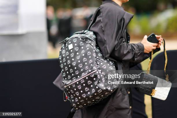 Guest wears a MCM backpack, during London Fashion Week September 2019 on September 16, 2019 in London, England.