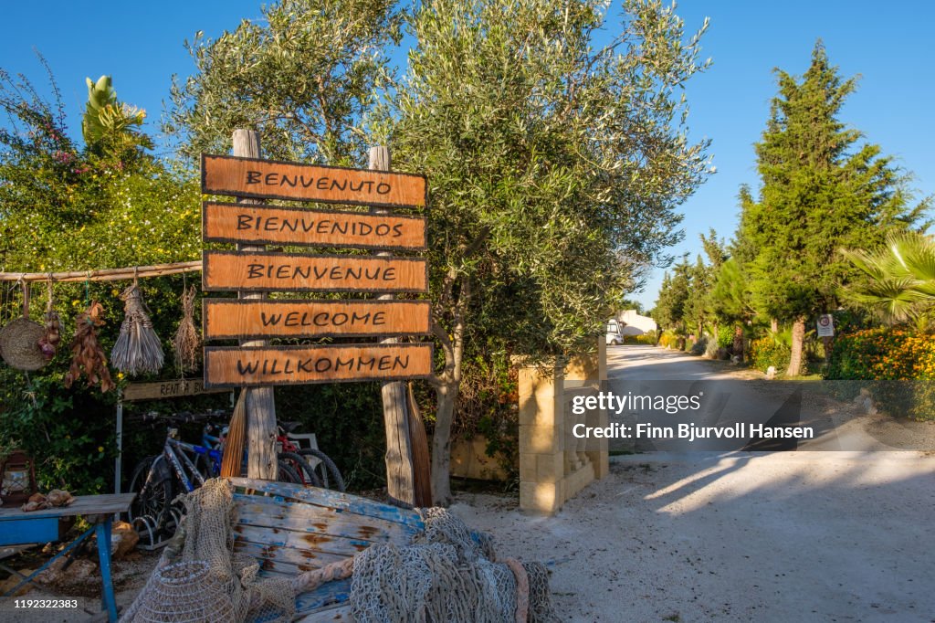Signs at the gate wish you welcome to a camping in Marsala, Sicily Italy