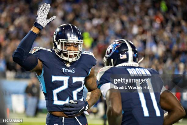 Derrick Henry celebrates after a touchdown by A.J. Brown of the Tennessee Titans during the second half of a game against the Jacksonville Jaguars at...