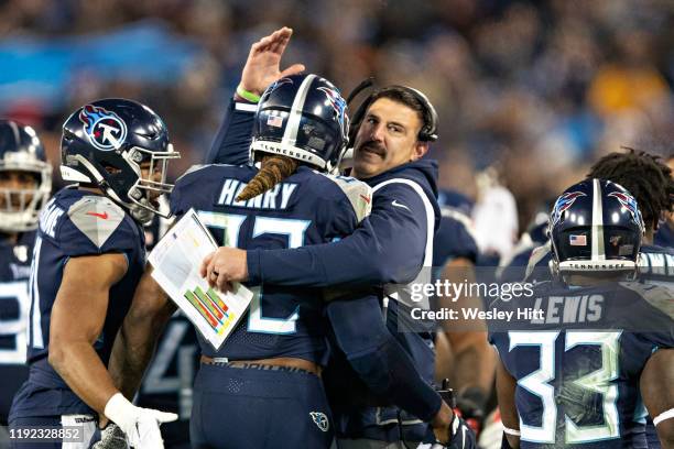 Head Coach Mike Vrabel congratulates Derrick Henry of the Tennessee Titans after scoring a touchdown during the second half of a game against the...